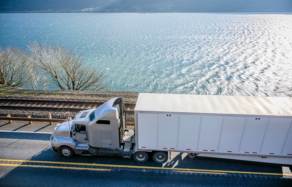 KWK Equipment Ltd truck and trailer on the road in Ontario